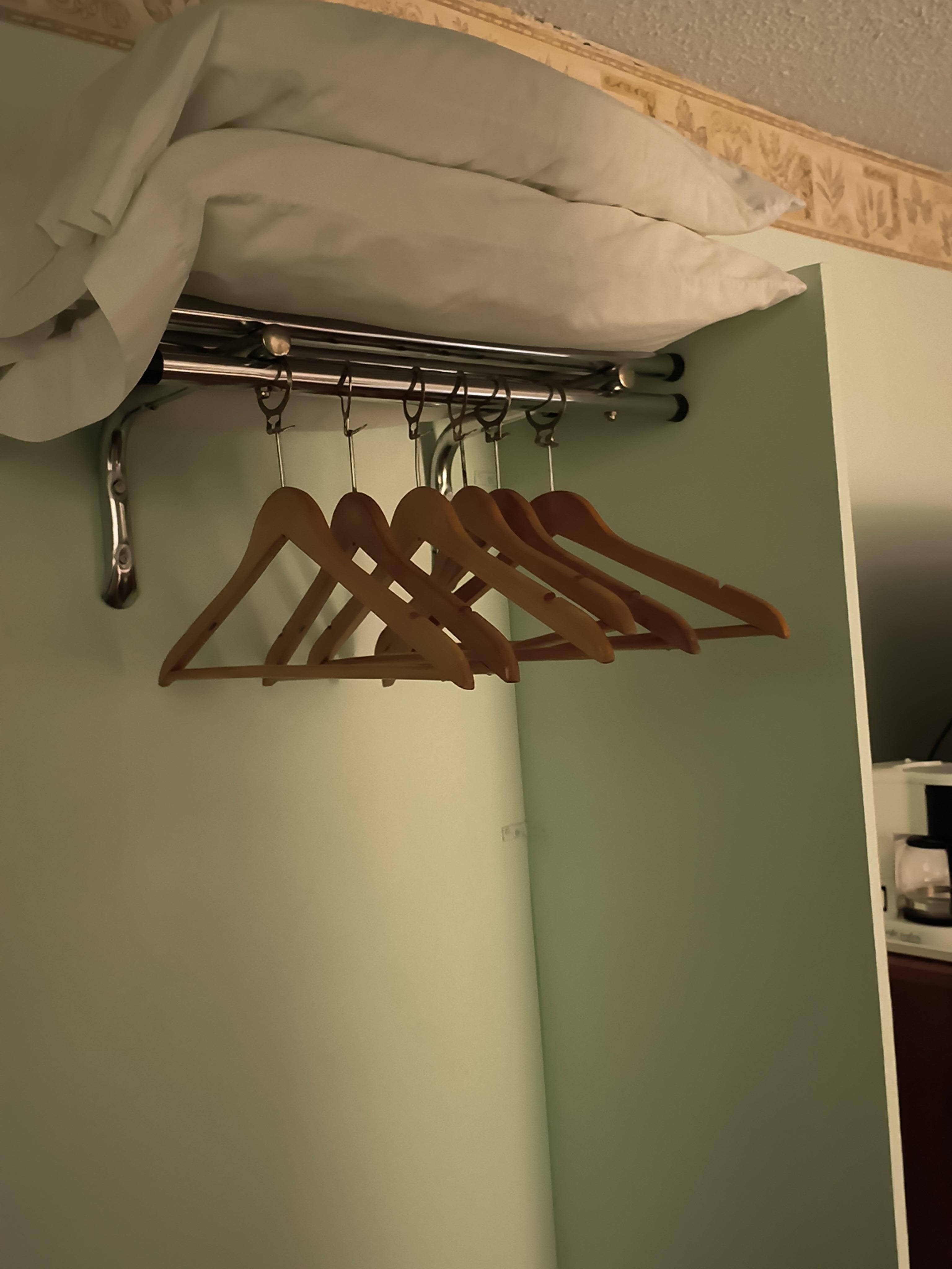 Clothing rod and additional pillows.