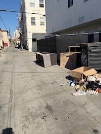 Garbage dumpster at parking entrance.