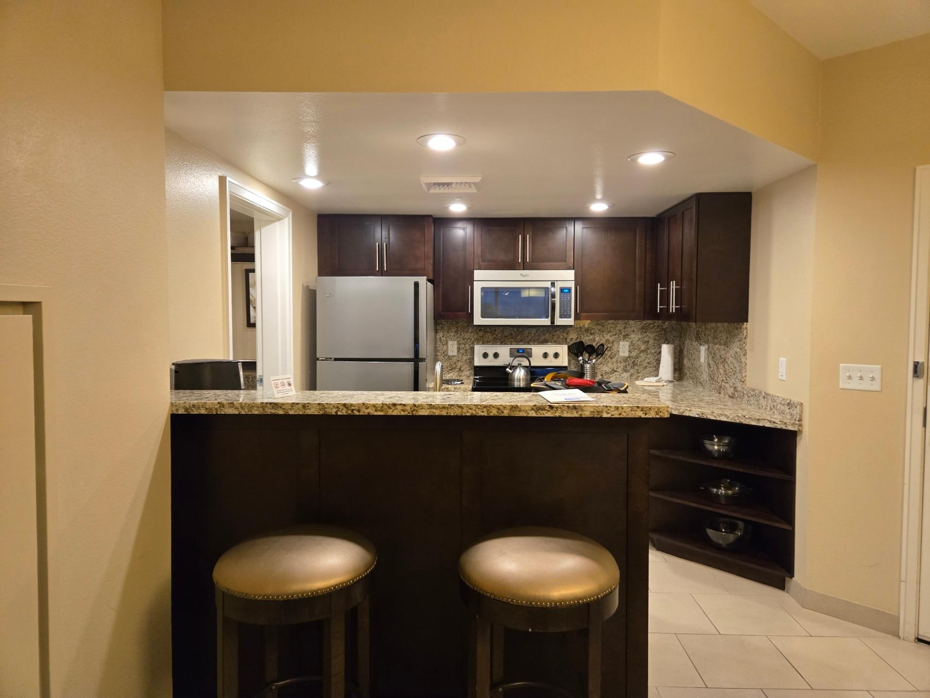 Full size kitchen. Door to bath is on the left of the refrigerator. You can enter the bath from the bedroom or kitchen