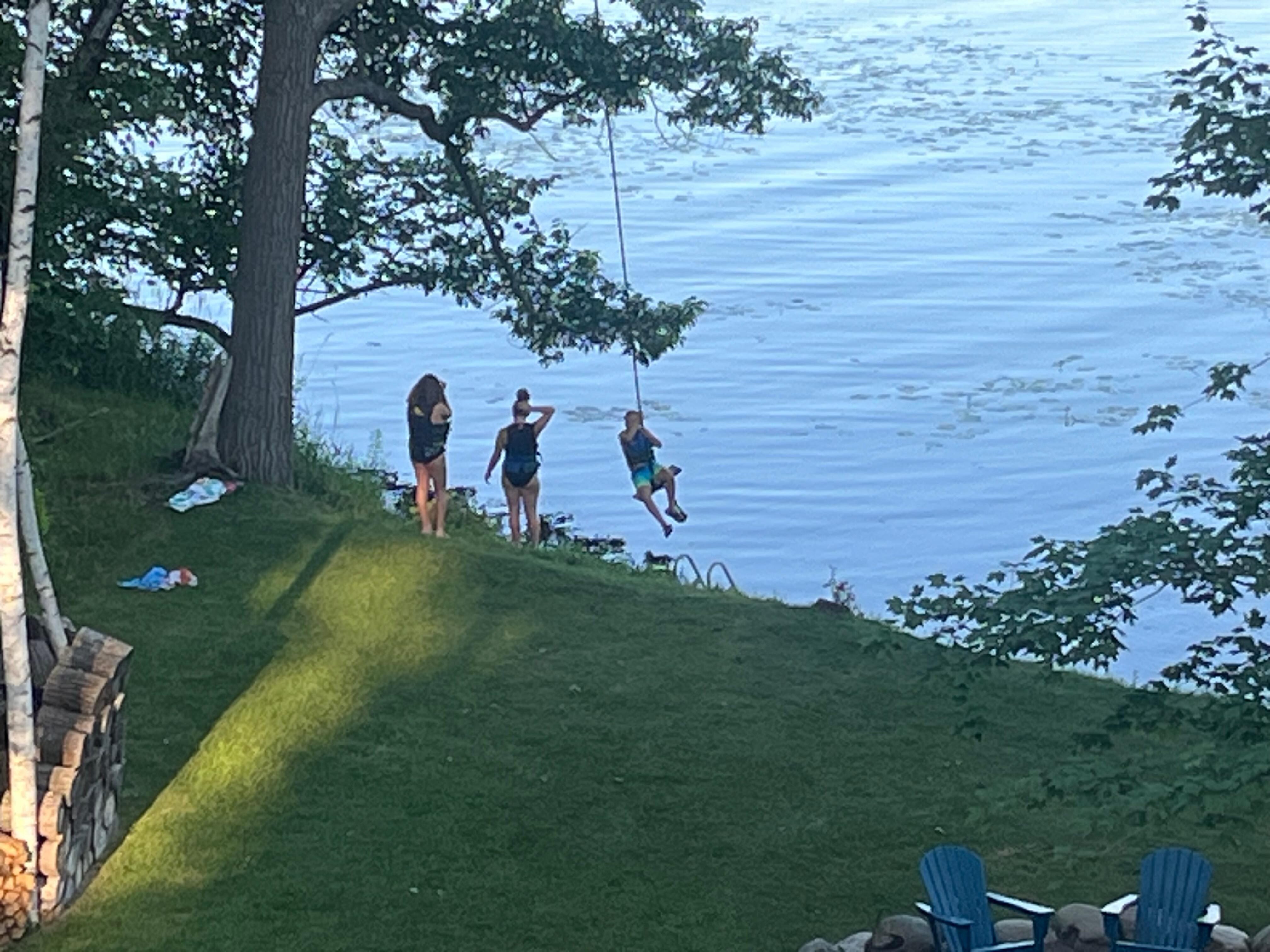 Kids enjoying the swing into the lake. The 