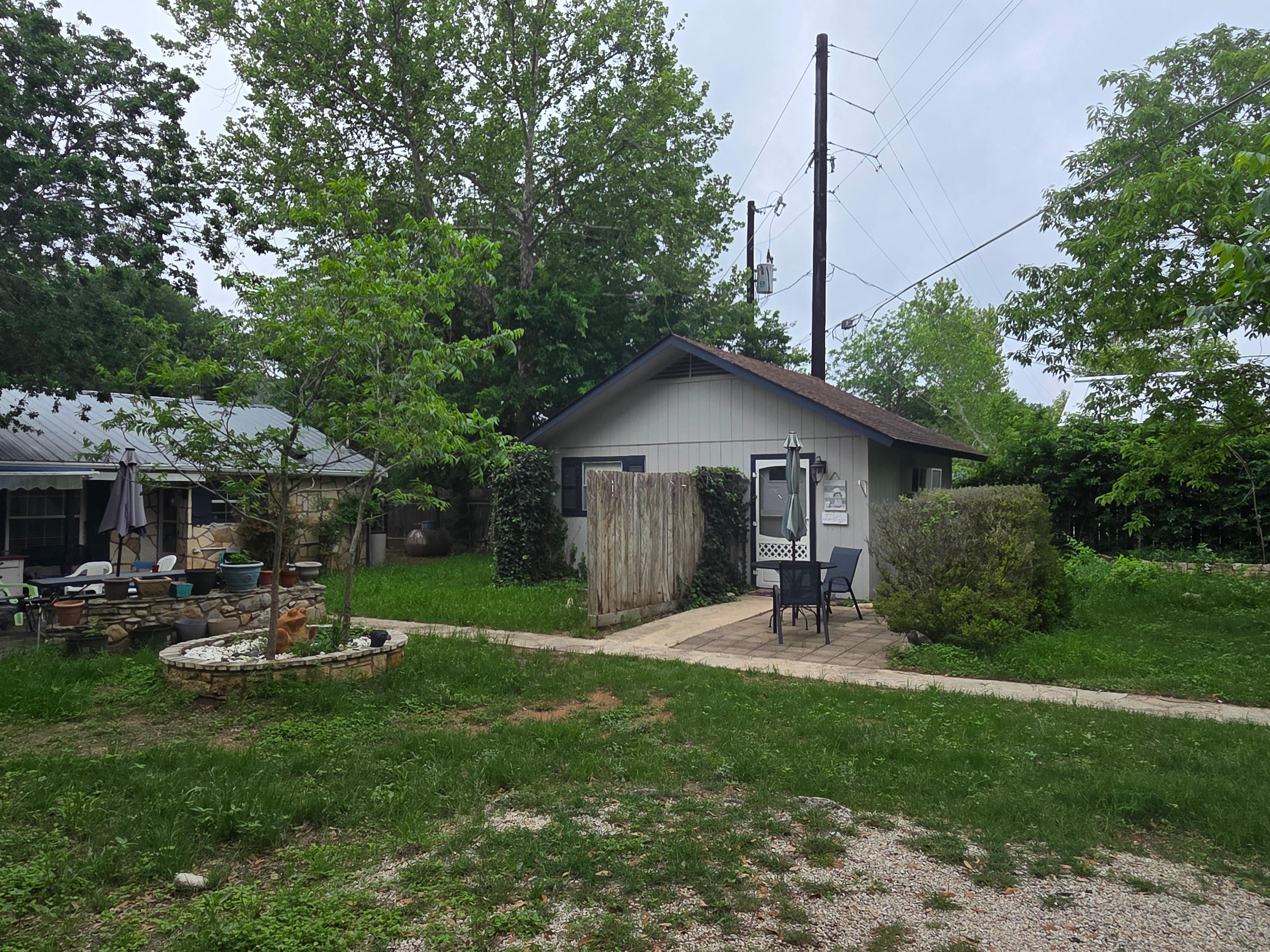 Outside of cottage. River is on the backside of the house on the left, down some steps and a rocky path. 