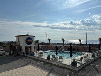 View from condo balcony of pool and ocean