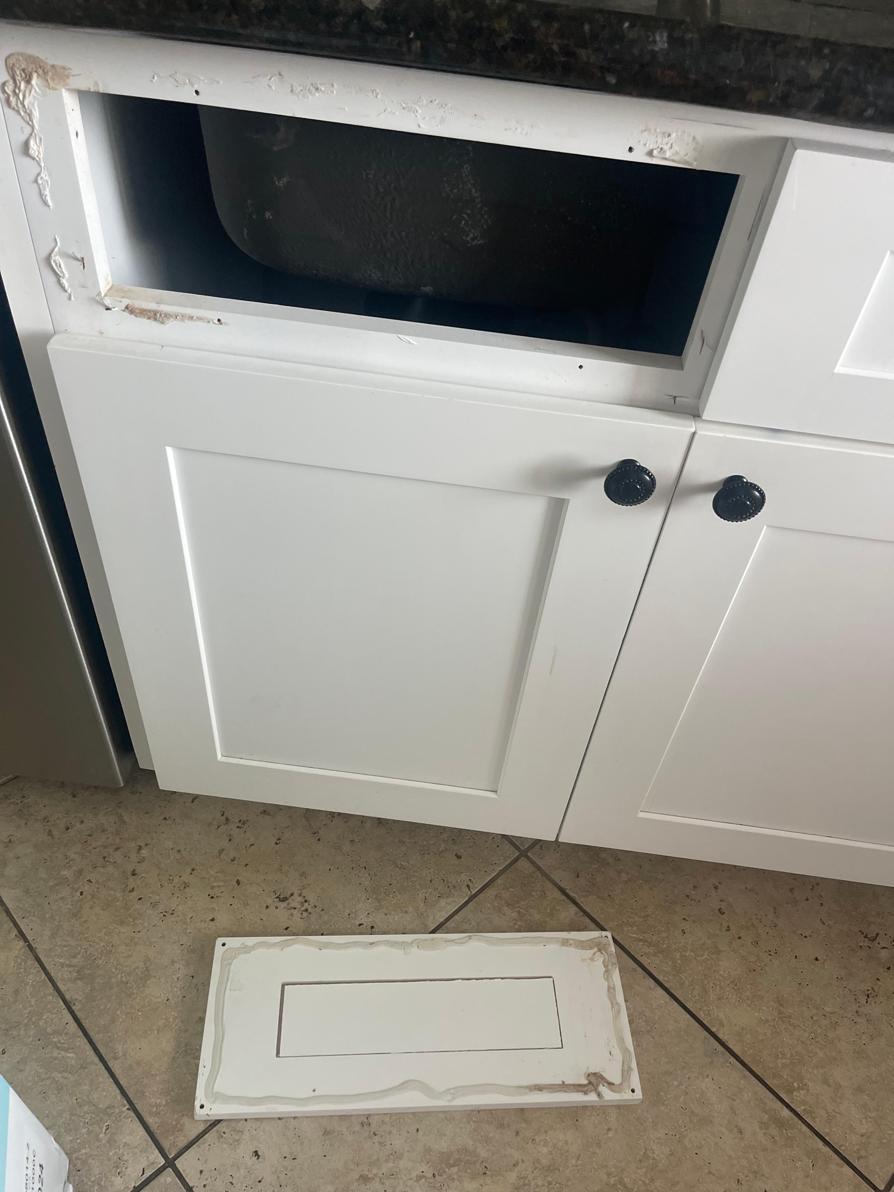 As you can see it was attempted to be glued back but fell off as soon as we opened the cabinet door below it. 