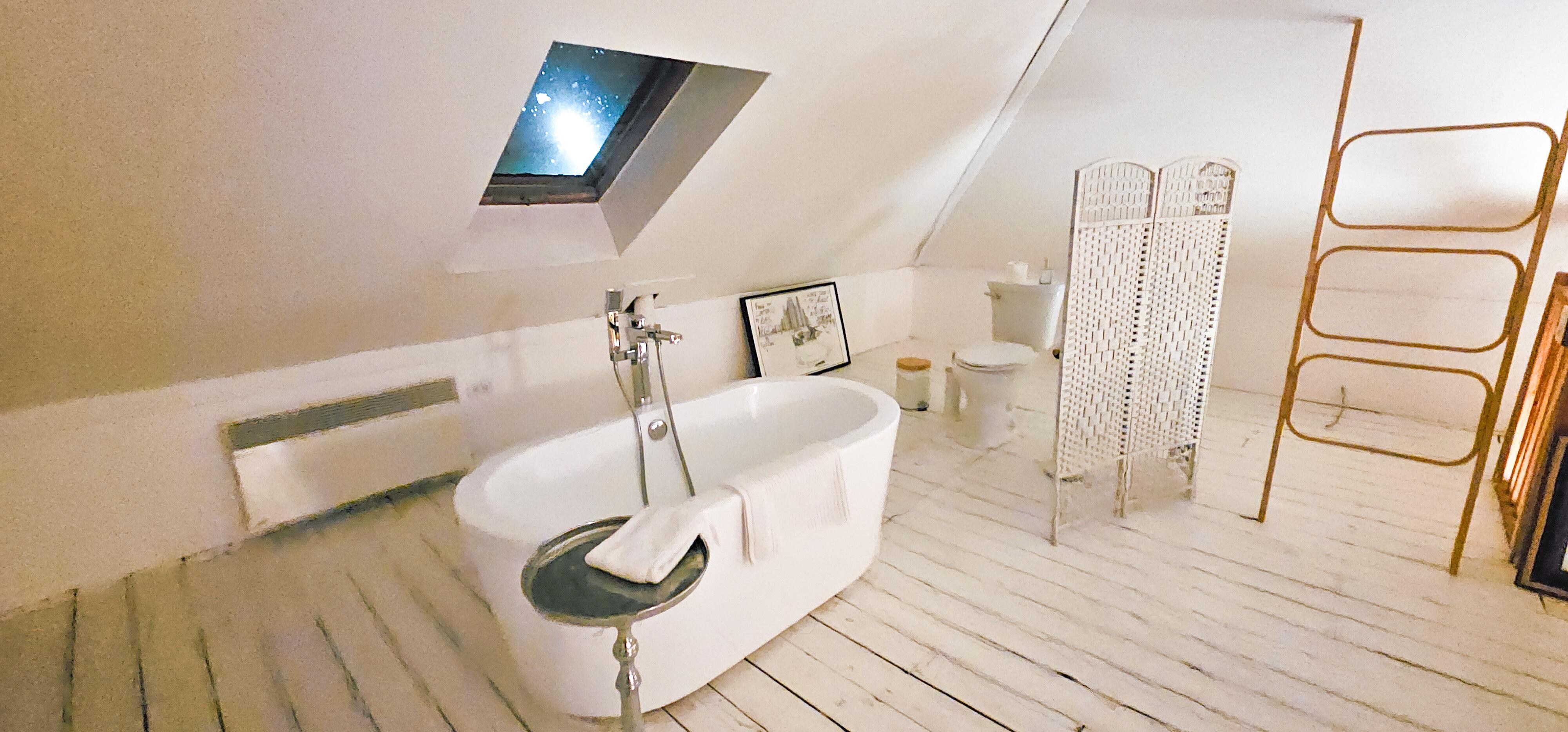 Bathtub and toilet in upstairs room