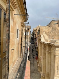 View from our room of a street with bars.