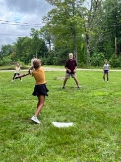 Wiffleball out front on newly mowed lawn.