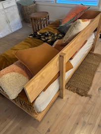This is not a proper lounge! It's a wooden bench with some pillows that fall through the gap at the back, which is straight, upright and uncomfortable!