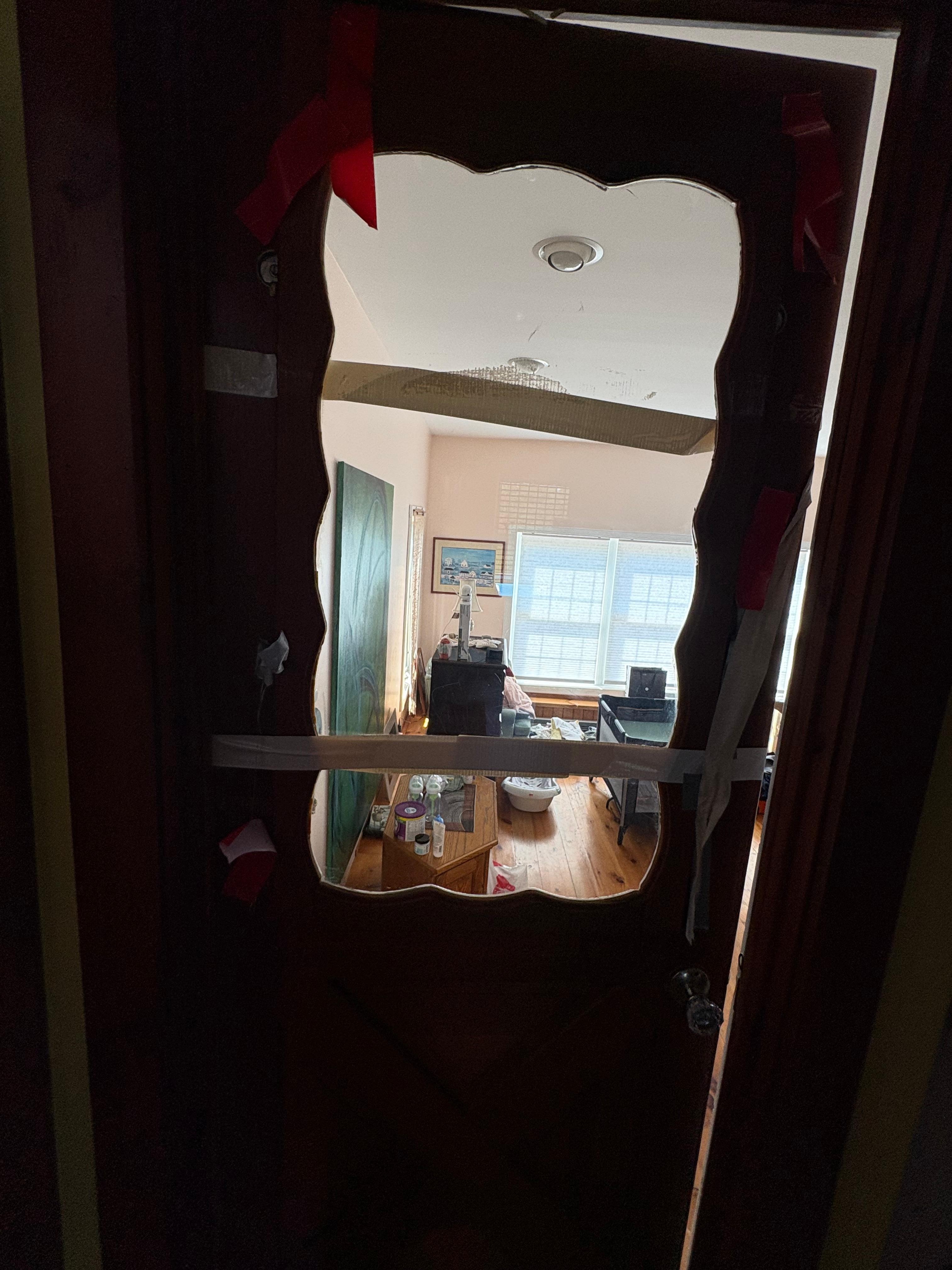 Door to one of the bedrooms open with duck tape and plexi-glass