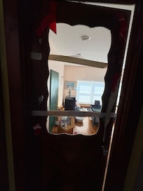 Door to one of the bedrooms open with duck tape and plexi-glass