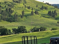 South view of the Valley. Kids flying remote control airplanes over the lawn