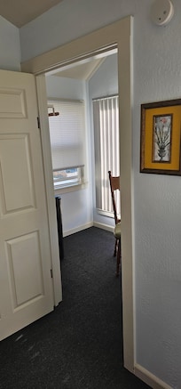 Side room with microwave, refrigerator, coffee maker, iron and desk. Sunny, airy and welcoming.