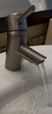 Maintenance turned down the water flow to slow the leaking of water onto and underneath the sink so it was easier to manage the overflow and flooding in the unit.