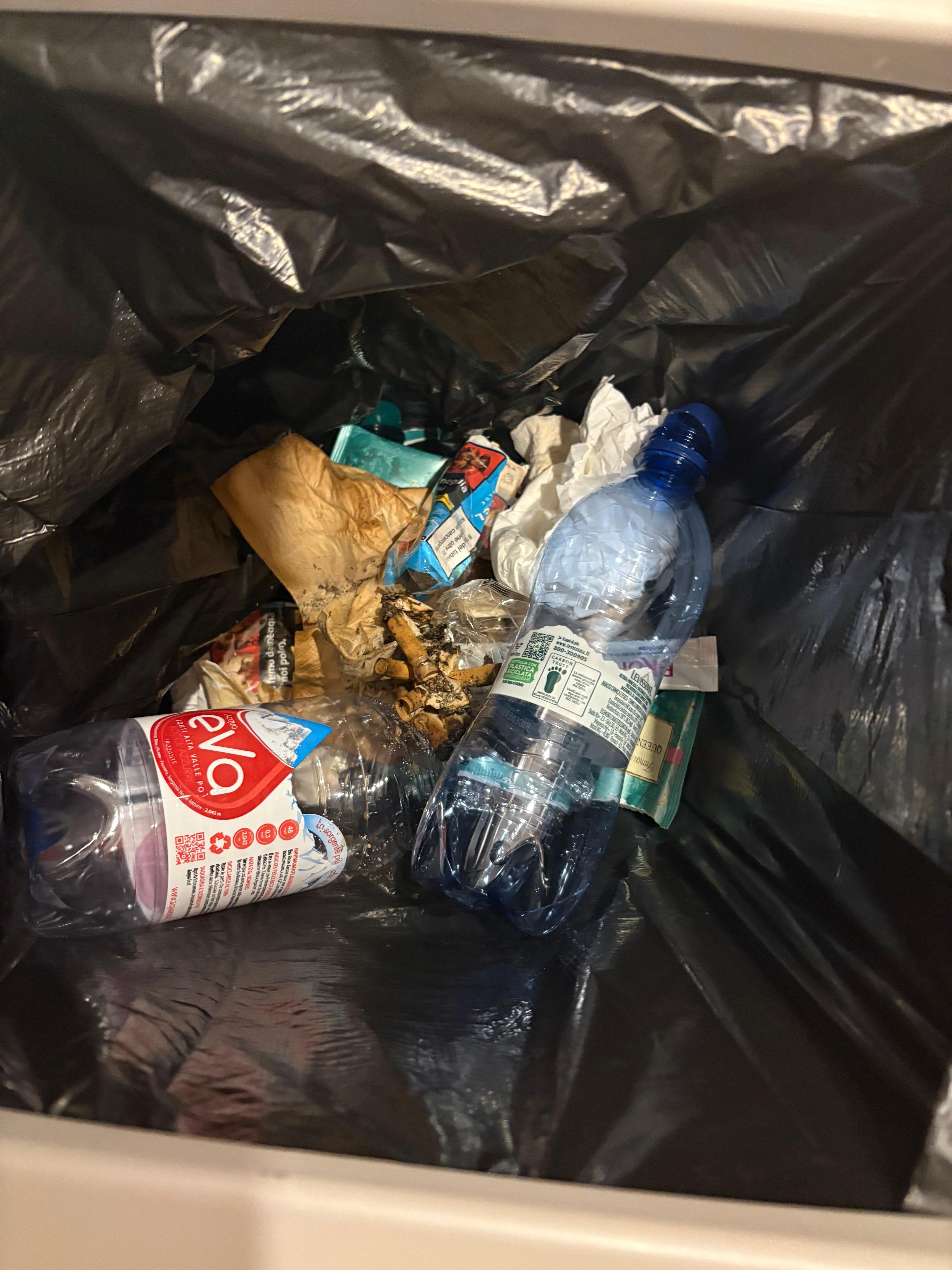 Bin full of rubbish and cigarettes in room 