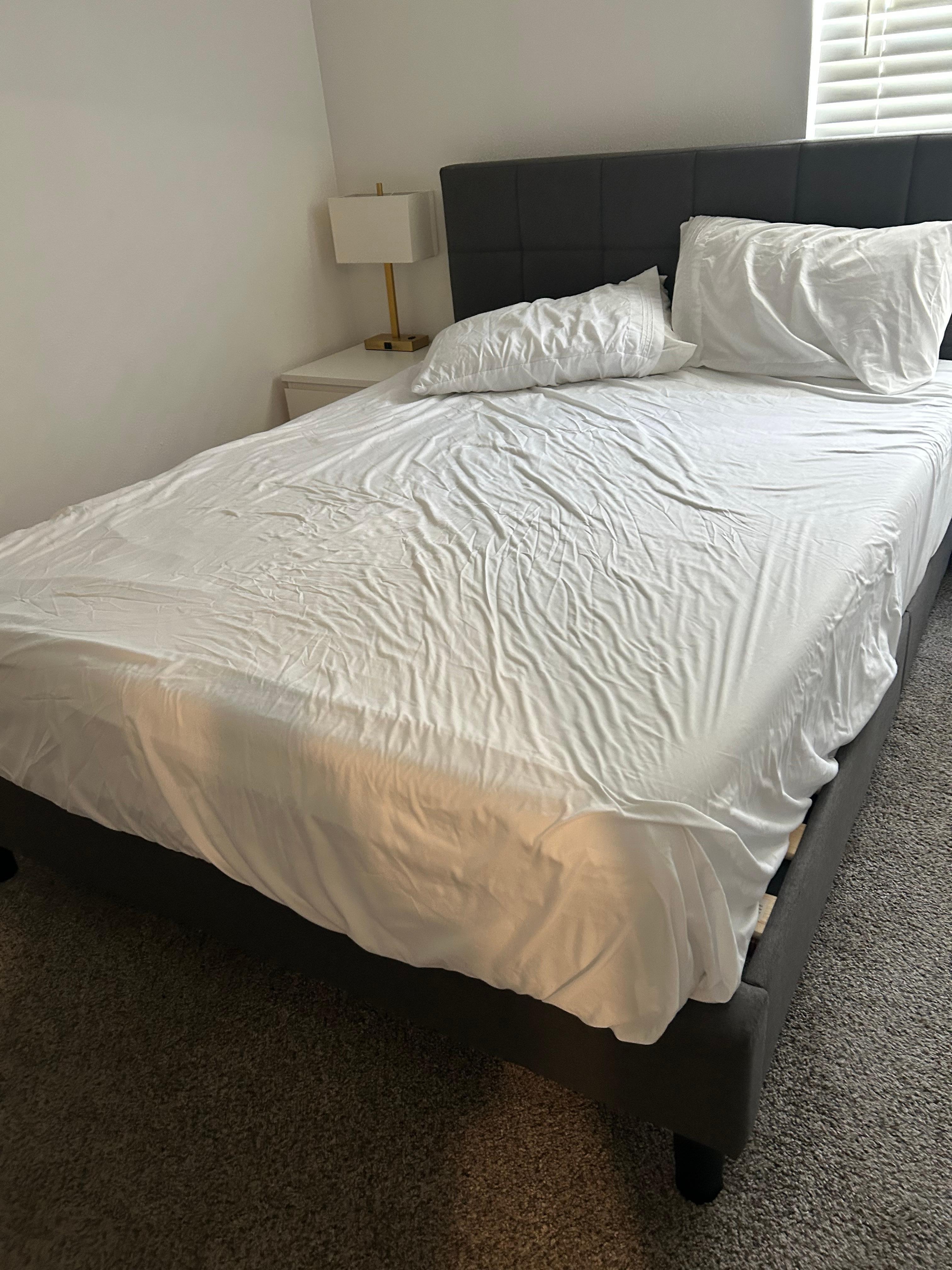 Beds tossed together; comforter hanging off of master