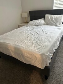 Beds tossed together; comforter hanging off of master