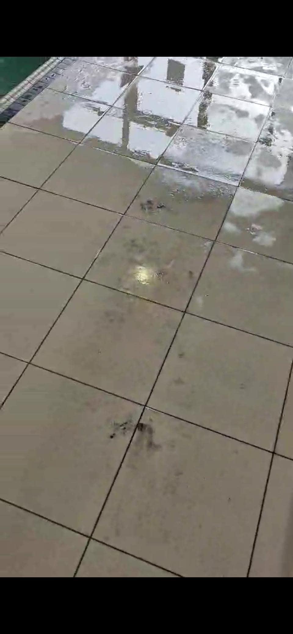 Construction workers foot steps mud entering pool water