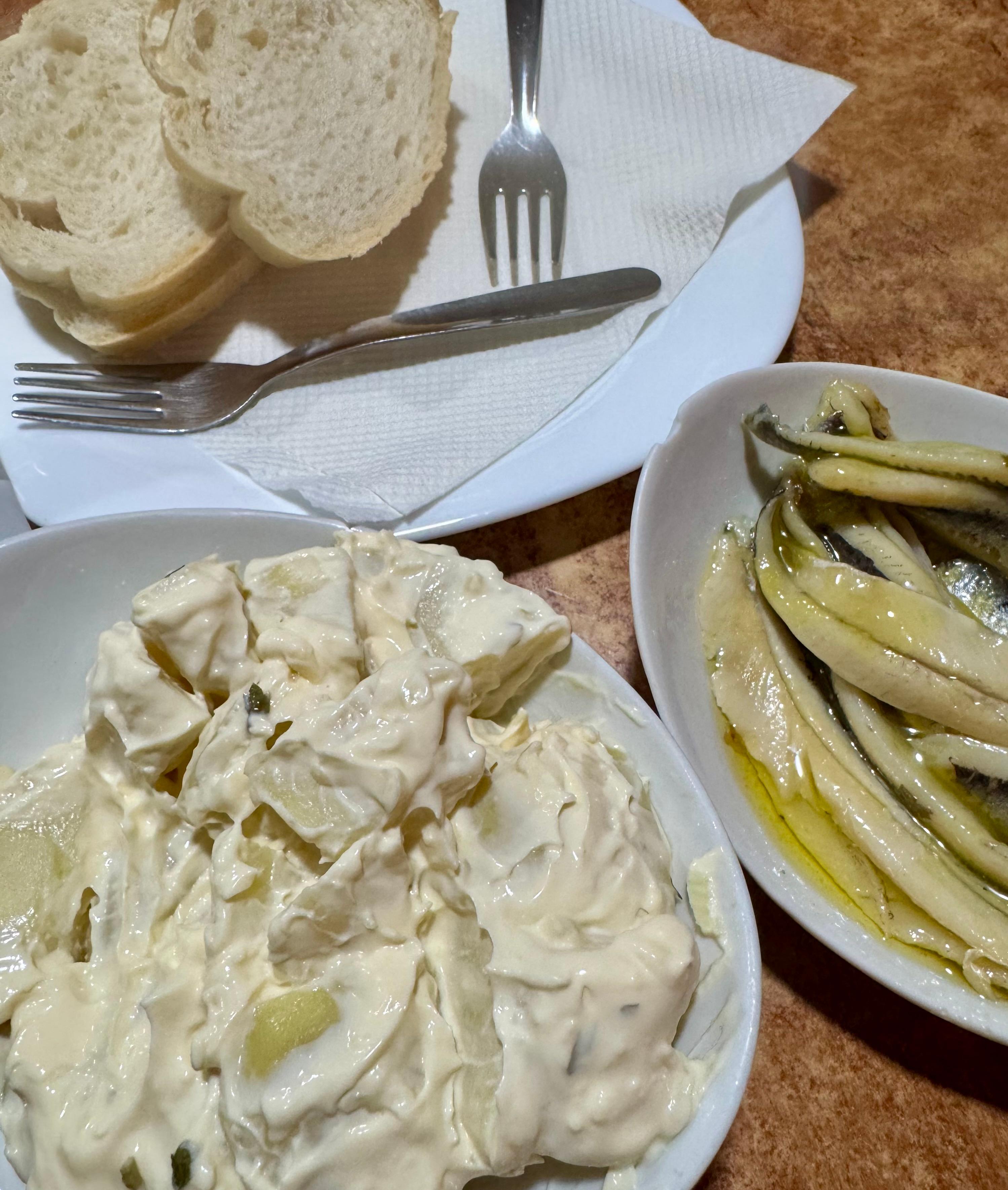 Potato w aoli anchovies , fresh bread and olives .