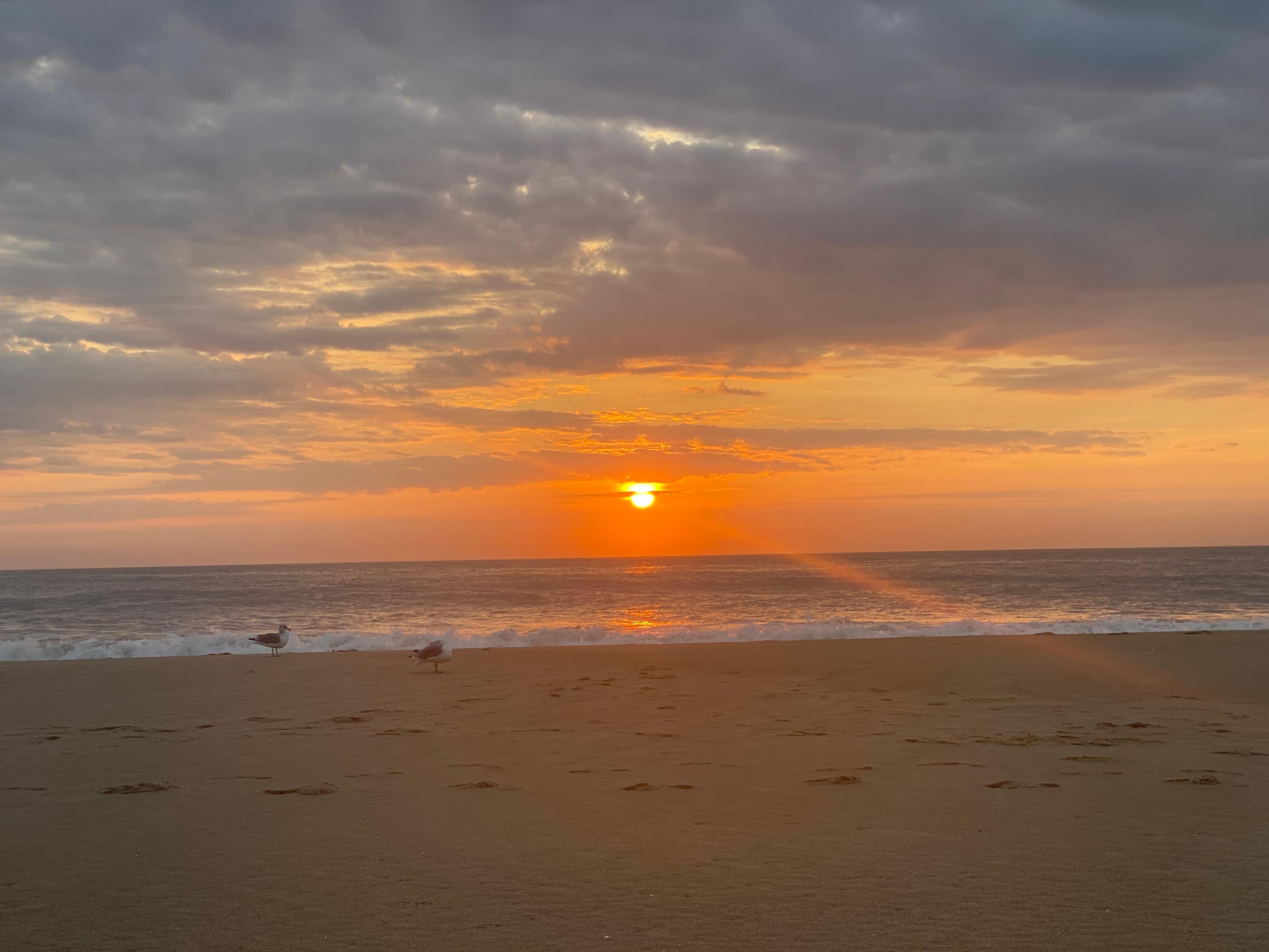 Sunrise on the beach front of the property  building 