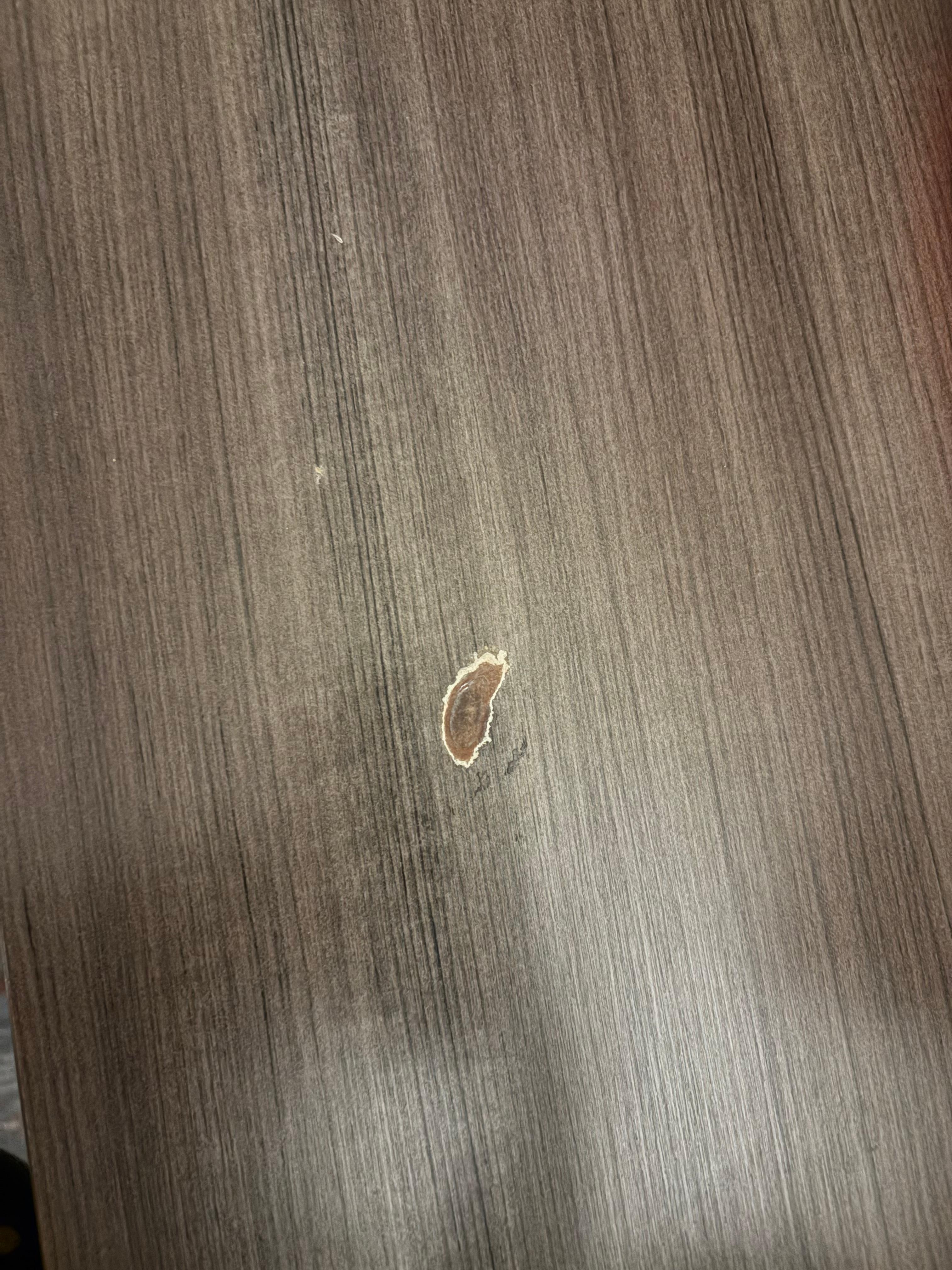 Burns/damage on the table of a smokeless room. 