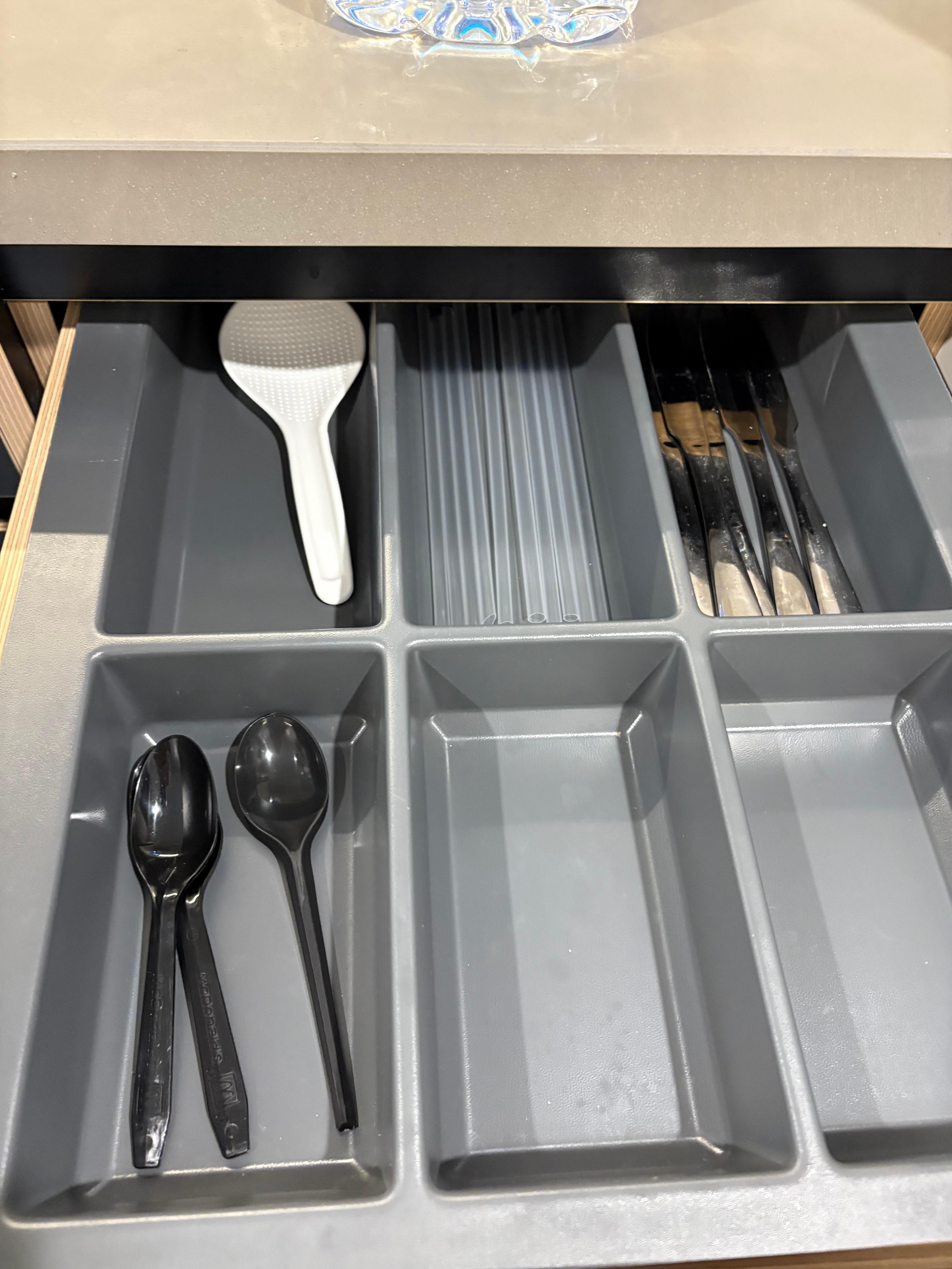 This is the cutlery drawer. It appears that other travellers have left disposables as there are few pieces of cutlery. 