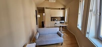 Kitchen includes dishes,  toaster,  kettle,  pans and pots.