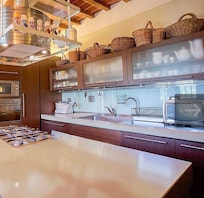 Kitchen stovetop and sink. Plenty of storage and kitchen necessities provided.