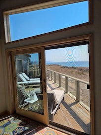 View from inside the house (great room sliding glass doors) looking south across the deck.