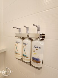 Bodywash, shampoo, and conditioner in the shower.