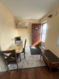 Front section of room! Bench, table and chairs, microwave and Fridge. No kettle? Perhaps you could have asked for one.