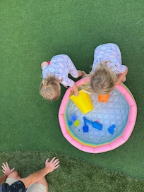 We put a little blow up pool on turf for the babies.