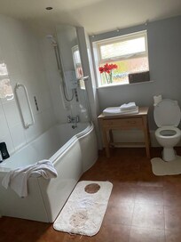 Bathroom with bath and shower