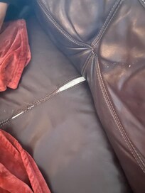 Ripped sofa which host tried to mask with a blanket