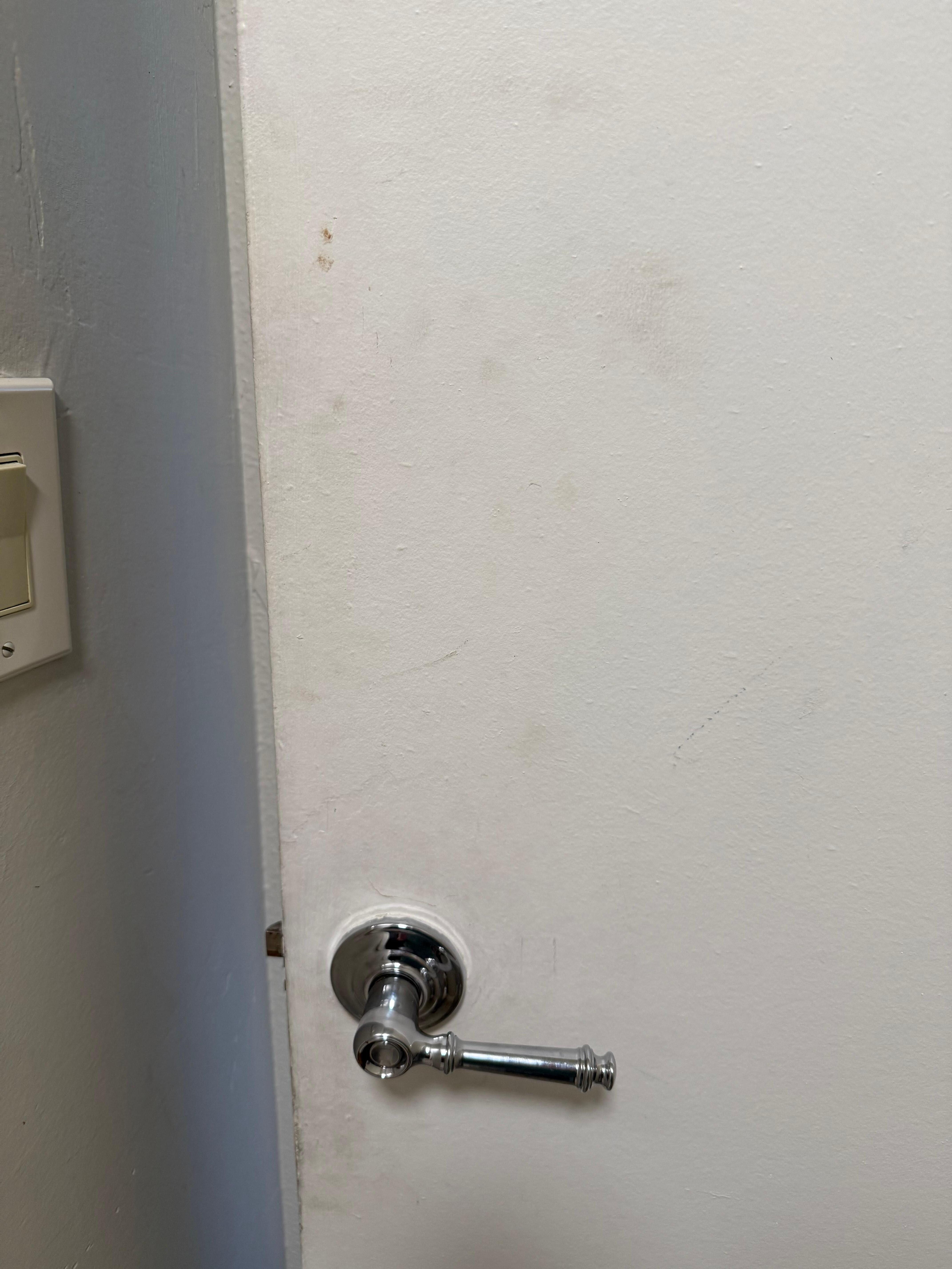 Gross, dirty bathroom door. 