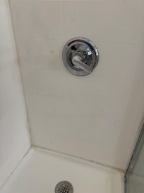 Splattered paint/caulk makes shower look filthy, it’s on all walls