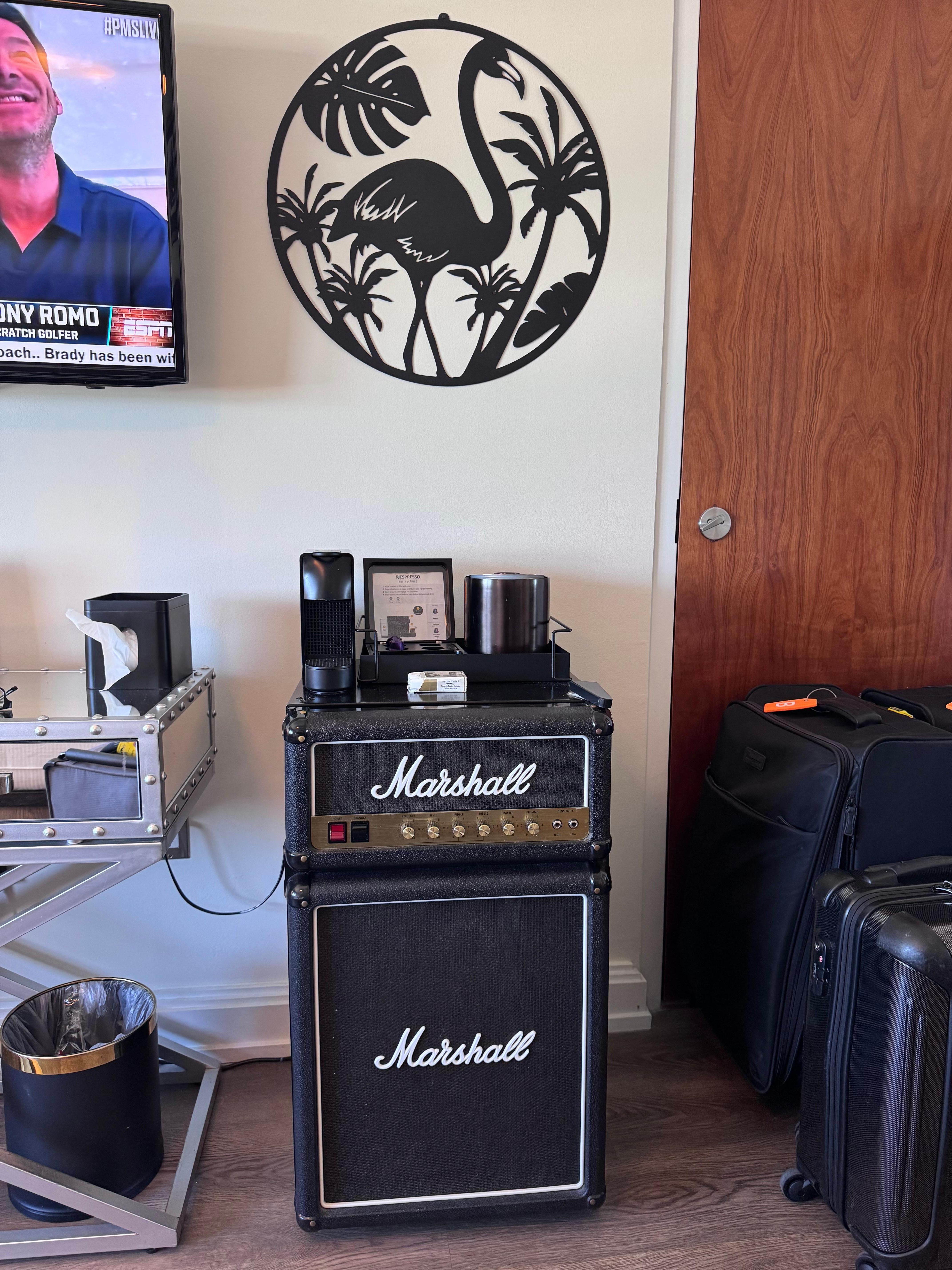 Nicely decorated room with cute fridge.