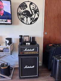 Nicely decorated room with cute fridge.