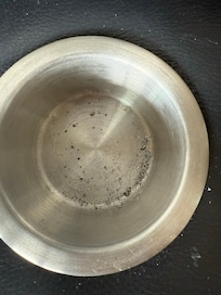 Cigarette ash in the cup holder of the couch.