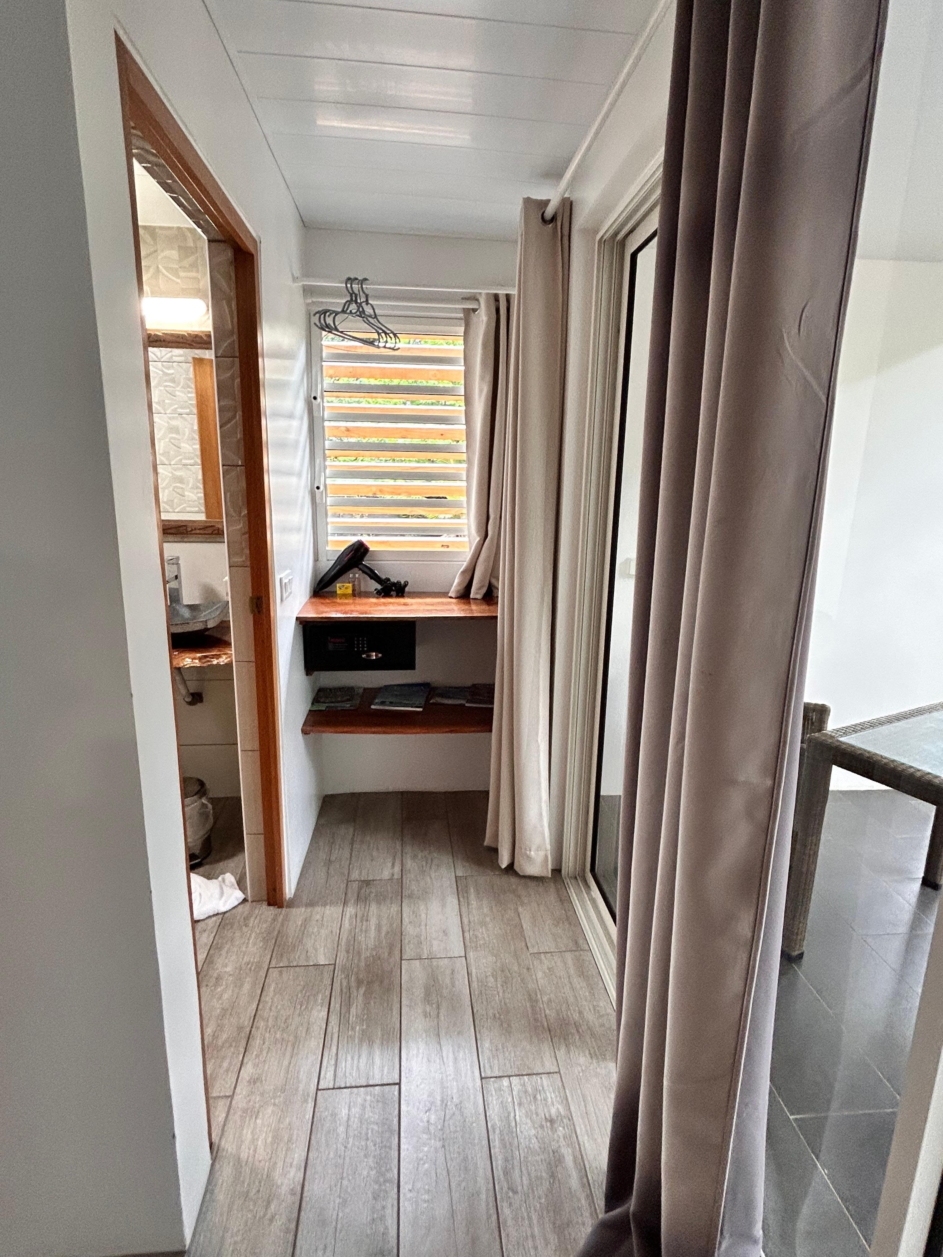 The clothes hanging area take from the foot of the bed