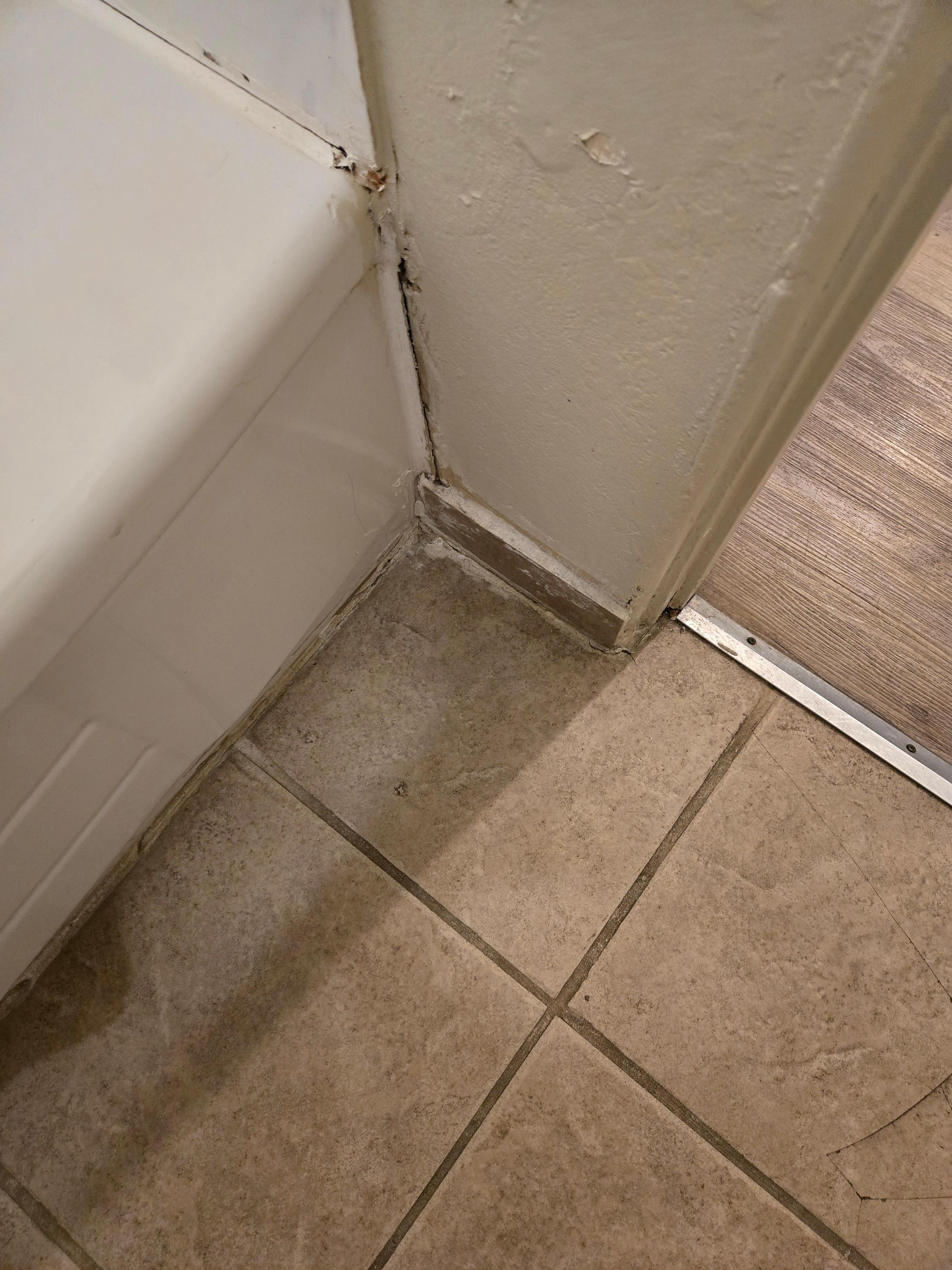 Terrible patch job, looks like black mold underneath
