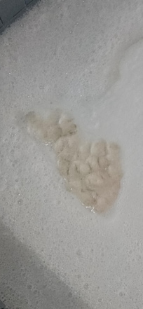 Some of the brown foam in the hot tub.