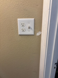 Peeling paint in the bathroom and toilet paper stuffed into strike plate on door