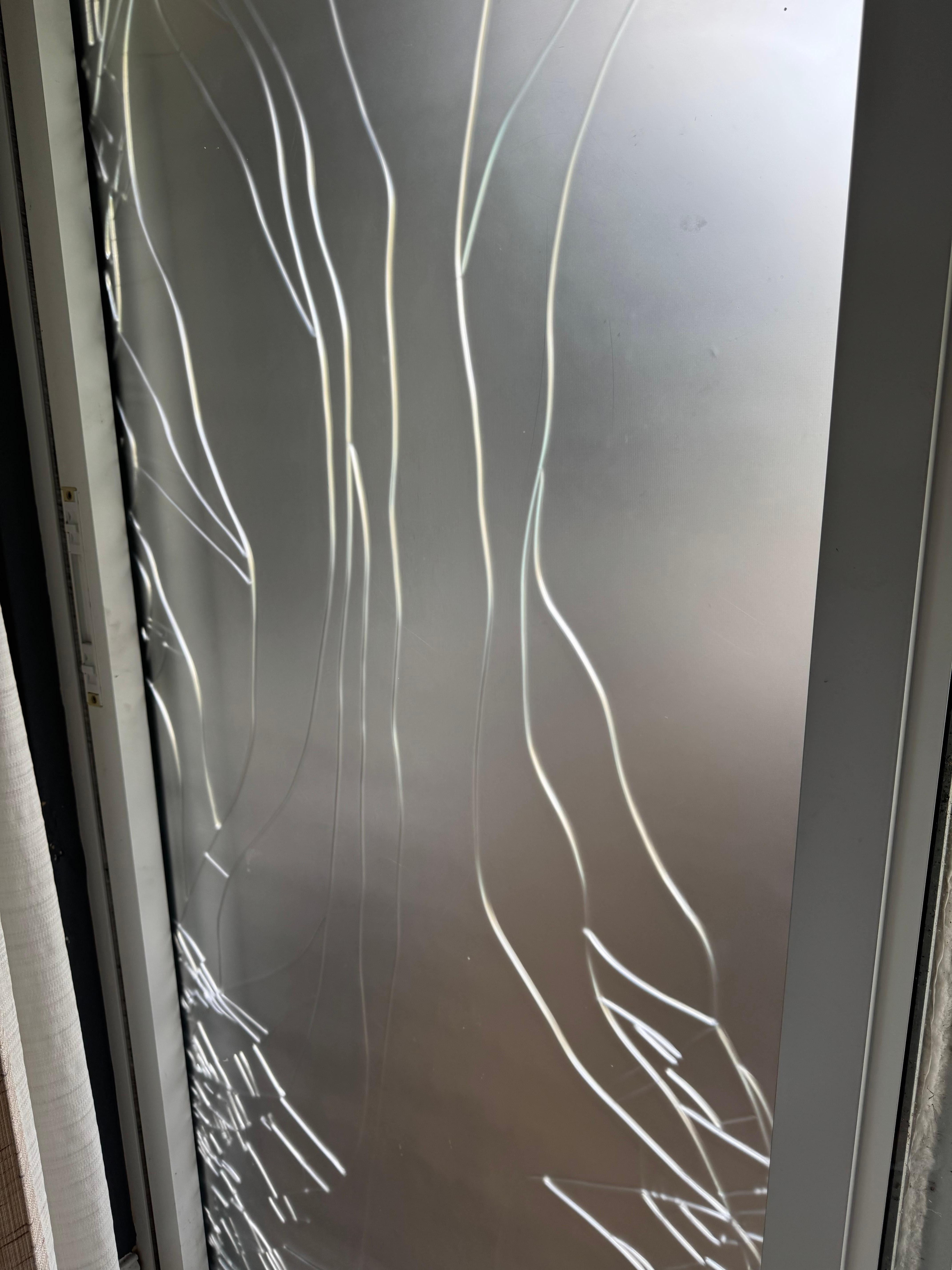 Broken glass door held with plastic film
