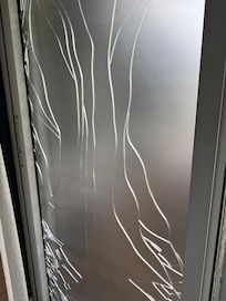 Broken glass door held with plastic film