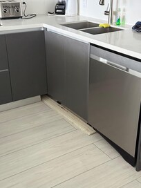 Broken baseboard in the kitchen that fell the first time we opened the dishwasher.