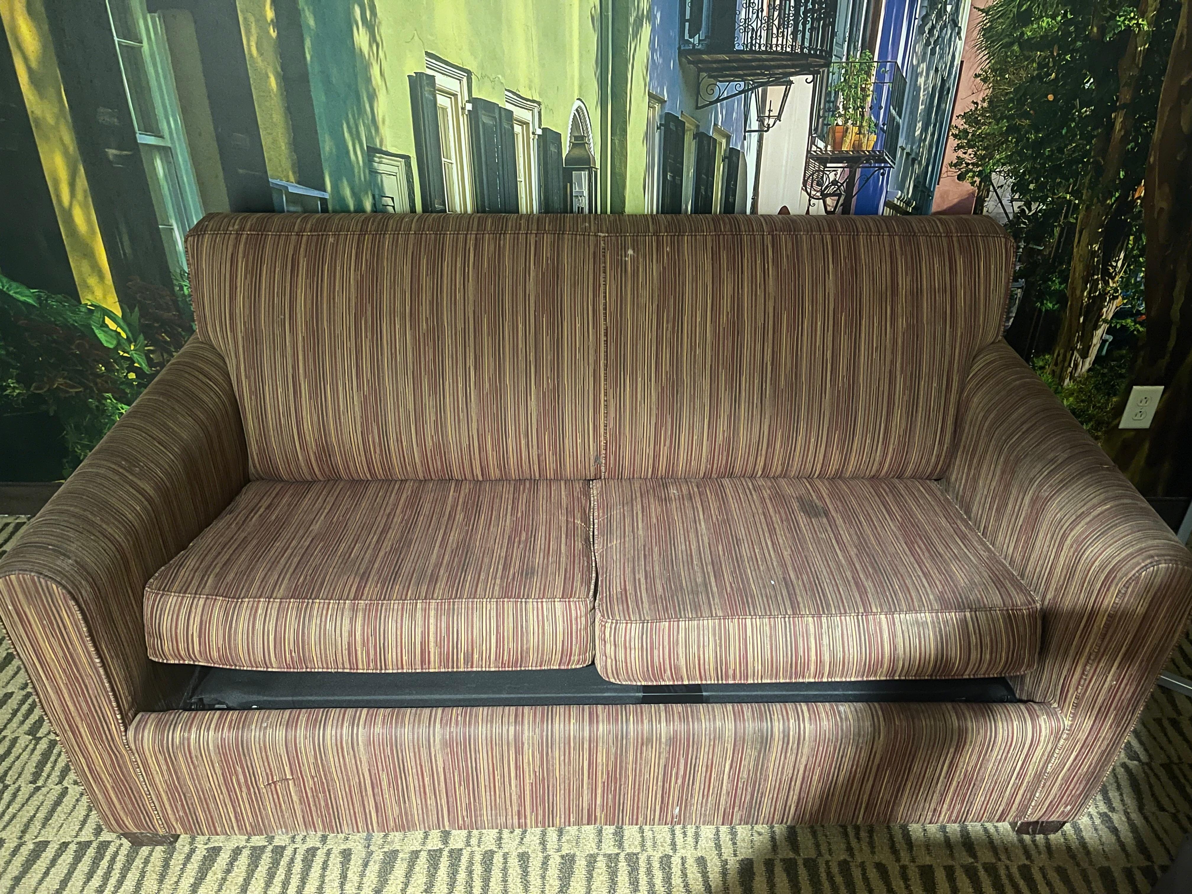 Old looking couch with stains