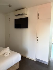 TV & cupboards in bedroom