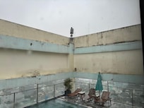 The pool area with half of the chairs available. In case of bad whether you can't use it since there is no roof.