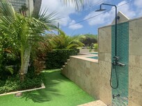 The medium-sized pool and shower in the front