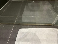 Mould along bottom seal of shower.