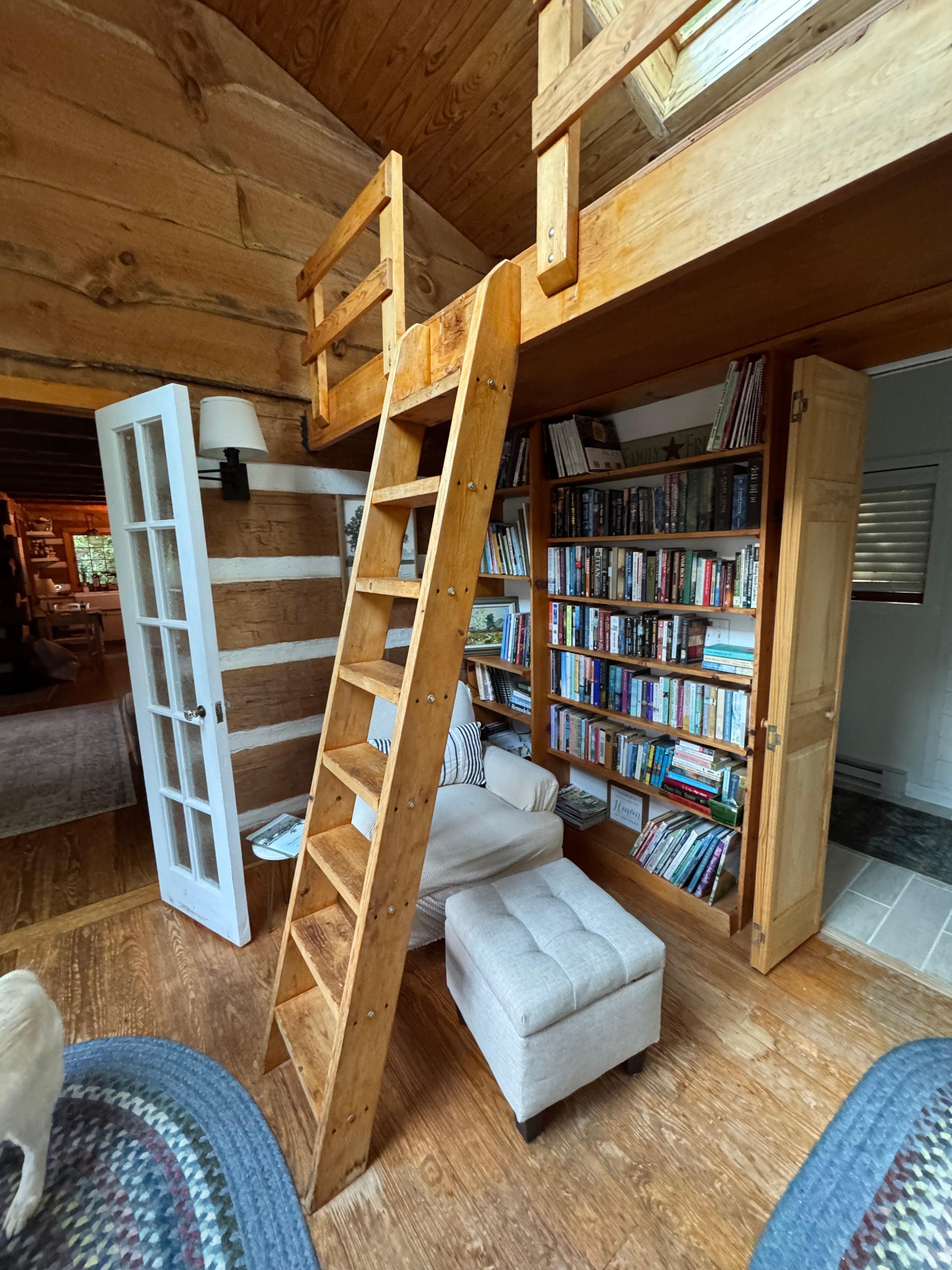 Cozy reading nook with a loft and greenhouse window.